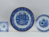 three blue and white plates and a small bowl