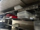 a kitchen with a lot of dishes on the shelves