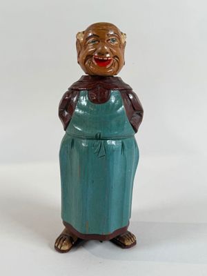 a figurine of a woman wearing a green apron