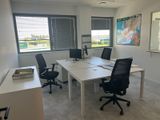 an image of an empty office with a desk and chairs