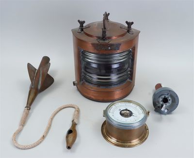 a small copper object with a rope and a clock