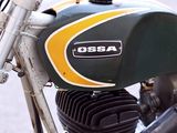 a green and yellow motorcycle parked on the side of the road