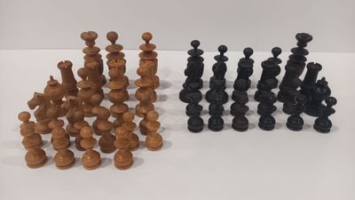 a group of chess pieces sitting on top of a white surface