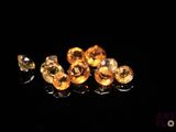 some yellow diamonds are laying on a black surface