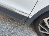 a close up of a car ' s tire with a denting on it