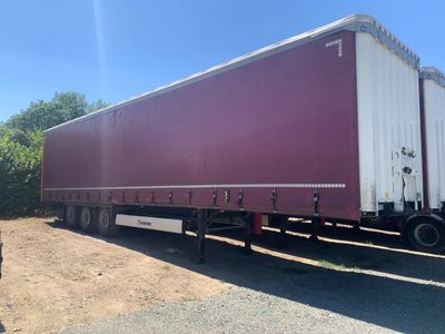 a large semi truck that is parked on the side of the road