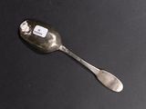 a spoon with a tag on it sitting on a table