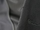 close up of a black leather jacket with a zipper on the back