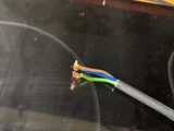 a close up of a wire with a wire connected to it
