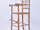 a wooden chair that is sitting on a white surface