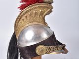 a helmet with a red feather on top of it