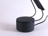a black table lamp that is on top of a table