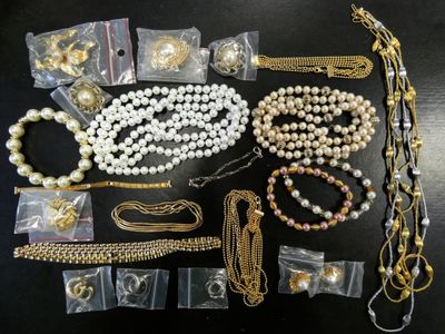 many different types of necklaces and bracelets laid out on a table