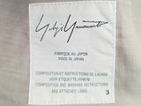 a close up of a label on a white shirt with black writing