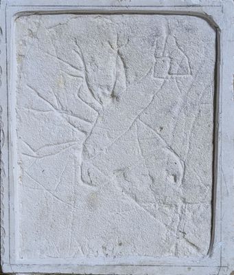 relief of a horse and rider on a wall in a park