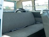 a seat in the back of a bus that is empty