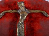 a metal crucifid with a crown on top of it