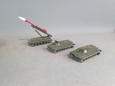 four toy tanks with a missile on top of them