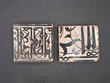 two tiles that are sitting on a table