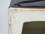 a close up of a small white box with a black handle