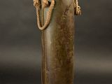 a metal container with a rope around it on a black background