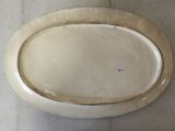 a white plate with a gold rim sitting on a table