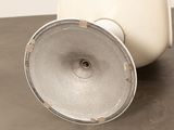 a white vase with a metal lid on a table