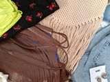 many different bags and purses laid out on a table