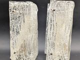 pair of silver glass bookends with a textured surface