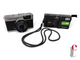 a black camera with a strap attached to it