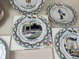 many plates with different designs on them on a table