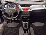 the interior of a small car with a steering wheel and dashboard controls
