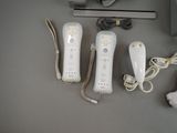two wii remotes sitting next to each other on a table