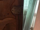 a wooden door that has a green curtain on it