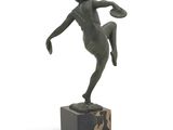 statue of a woman kicking a soccer ball on a marble base