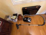 a vacuum that is sitting on the floor next to a window