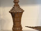 a bird that is sitting on a table next to a vase