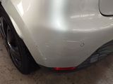 the rear end of a car with a denting dent on it
