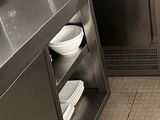 a small kitchen with stainless steel appliances and dishes on the counter