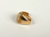 a close up of a gold ring on a white surface