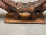 a wooden bench that is sitting on a wooden stand