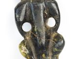 a close up of a statue of a person sitting on a chair