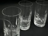 three glasses sitting on a table with a black background