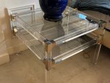a glass table with a blue vase on it