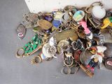 a pile of assorted keychains on a table