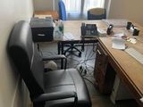 a desk with a chair and a computer on it
