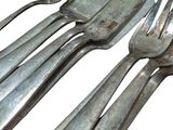 four forks and two spoons sitting on a table