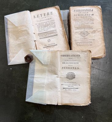 three old books sitting on top of a table next to each other