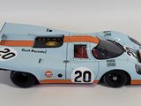 a close up of a toy race car on a white surface