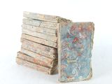 a stack of old books sitting on a white surface